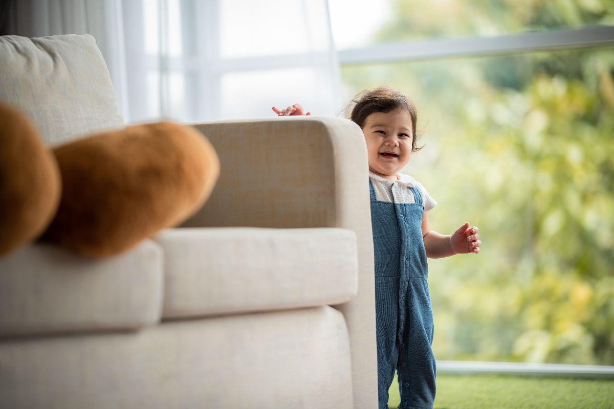A toddler cruising in a family-friendly condo