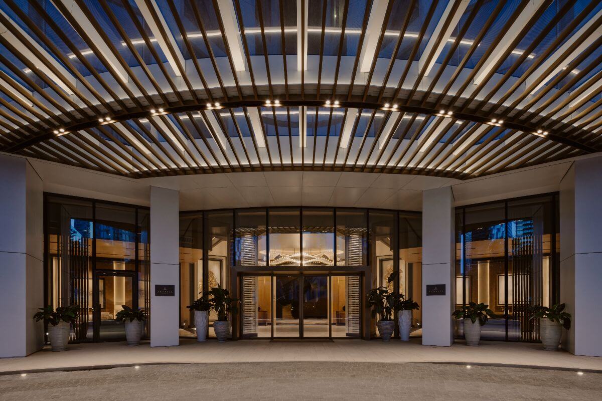 Elegant entrance lobby of Aurelia Residences with illuminated canopy and refined architectural details