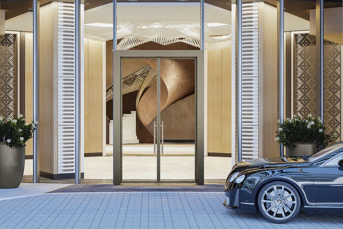 Aurelia Residences entrance with glass doors, refined lighting, and a luxury car by the driveway