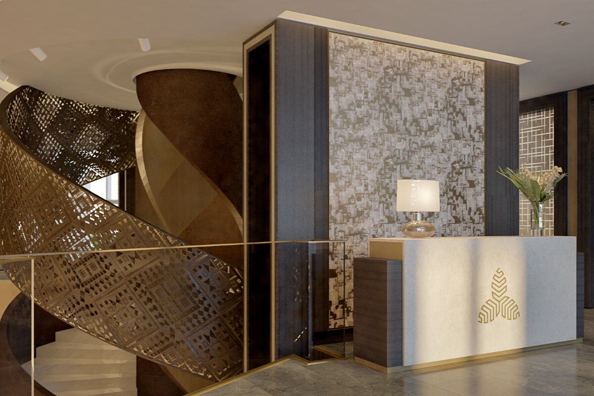 Aurelia Residences reception area with sculptural staircase, decorative wall panels, and front desk