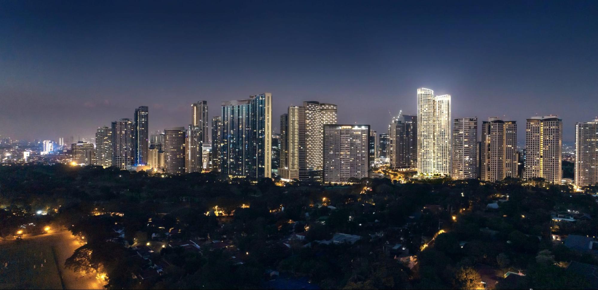 Bonifacio Global City skyline at night with illuminated high-rise residential and commercial towers