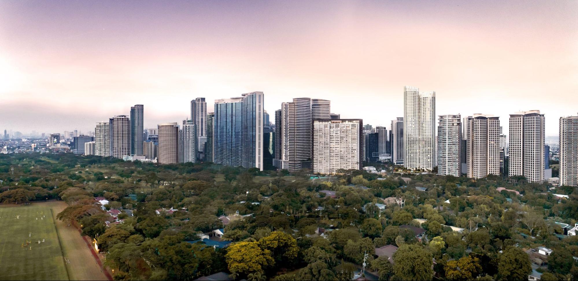 Daytime aerial view of Bonifacio Global City skyline surrounded by lush greenery in Taguig