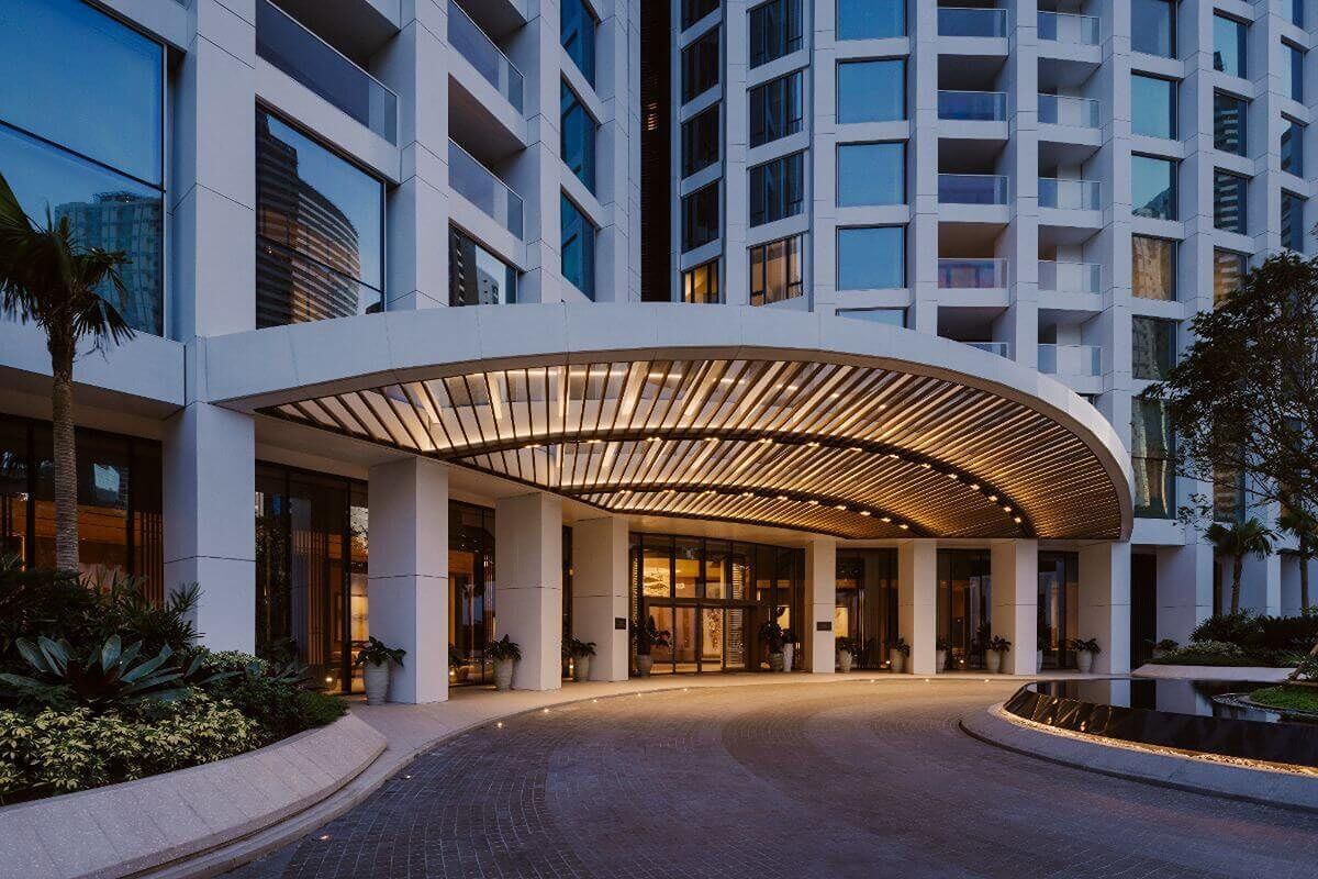 Illuminated entrance canopy of Aurelia Residences luxury condominium in BGC at dusk
