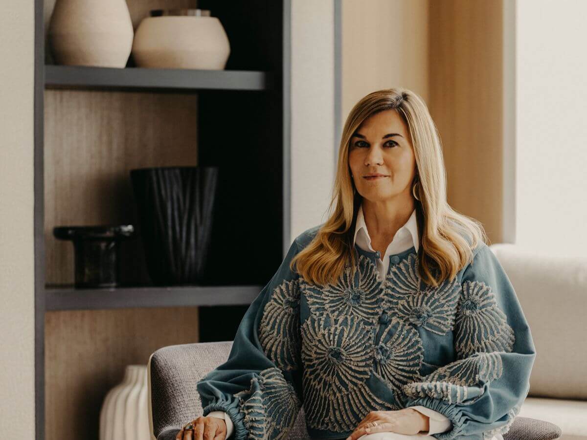 Woman seated in a refined luxury condominium interior, representing the affluent tenant market in BGC