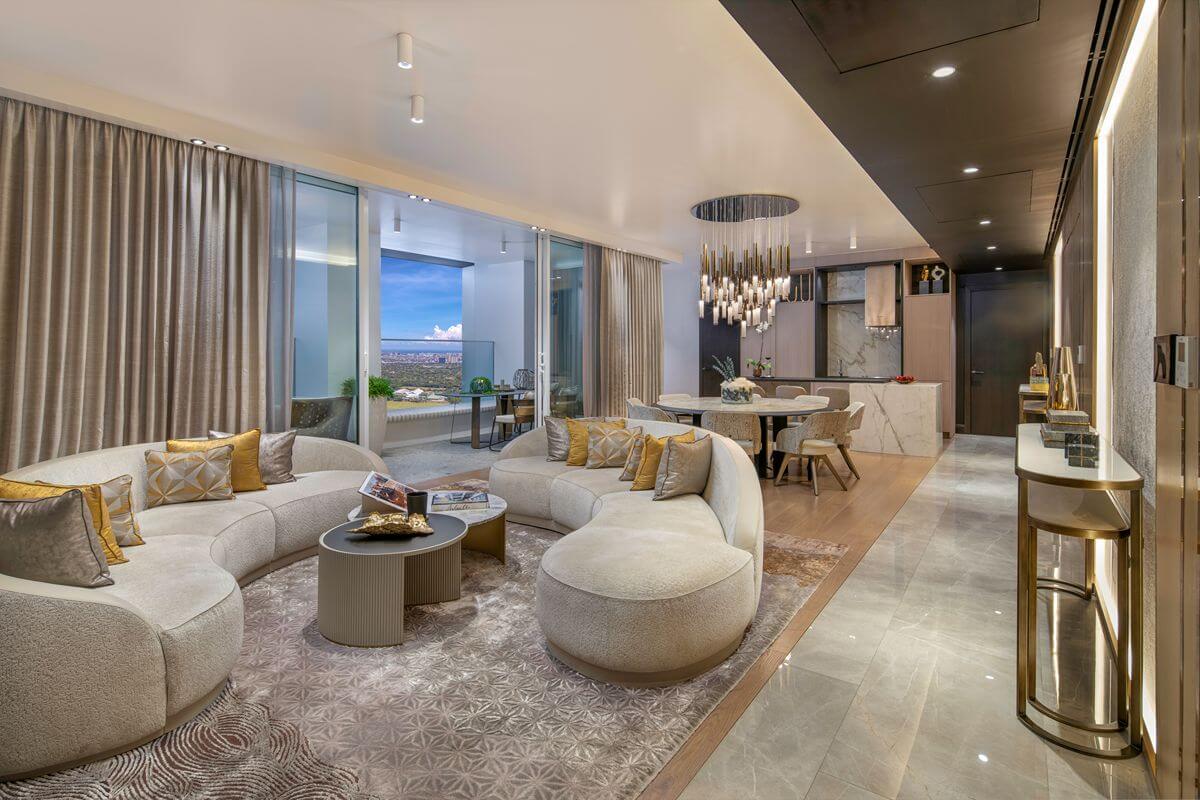 Elegant Aurelia Residences living and dining area with curved seating, refined interiors, and floor-to-ceiling windows